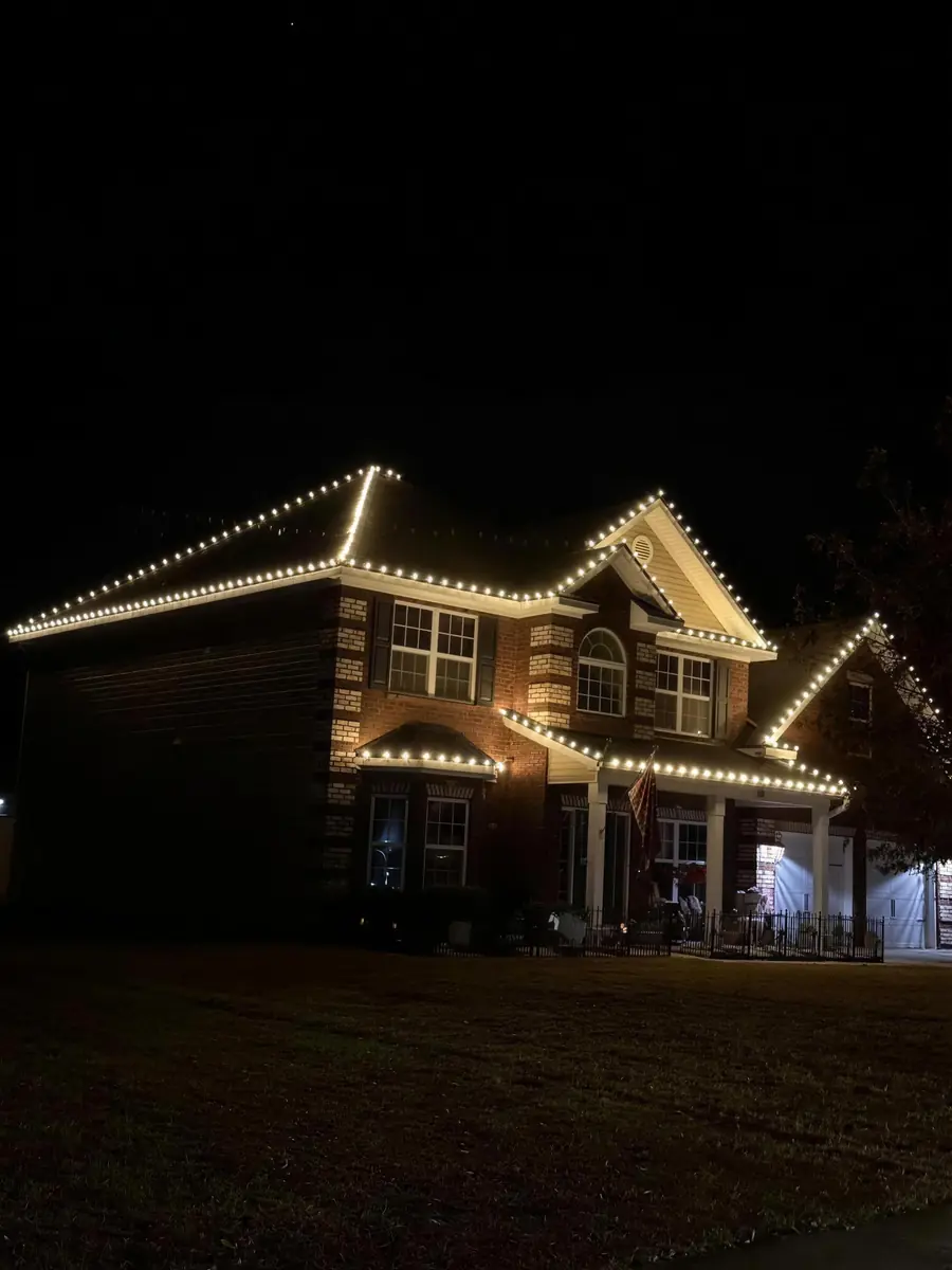 Every gable and peak traced in warm white bulbs