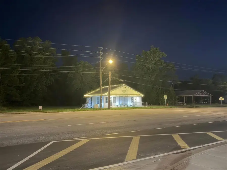 The same storefront from across the road at dusk